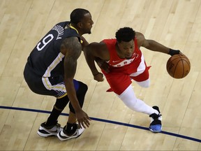 Warriors’ Andre Iguodala defends against Raps’ Kyle Lowry during Game 4 of the NBA Finals on Friday night in Oakland. (GETTY IMAGES)