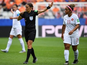 Referee Stephanie Frappart of France gestures next to Canada's midfielder Desiree Scott during the Women's World Cup Group E match between Netherlands and Canada, on June 20, 2019, at the Auguste-Delaune Stadium in Reims, France.