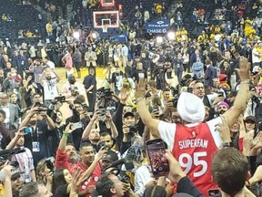 Raptors superfan Nav Bhatia celebrates Toronto's win Friday night over the Golden State Warriors in Oakland, California