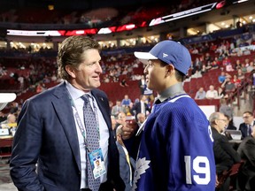 Nicholas Robertson, the 53rd selection overall at the NHL draft, speaks to Maple Leafs coach Mike Babcock at Rogers Arena on Saturday. (Bruce Bennett/Getty Images)