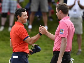 Rory McIlroy reacts with Webb Simpson after winning the 2019 RBC Canadian Open golf tournament at Hamilton Golf & Country Club. (Eric Bolte-USA TODAY Sports ORG)