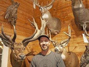 Rion White, a taxidermist from Moose Jaw, Sask., poses in his shop before removing Mac the Moose's antlers Wednesday, June 5, 2019.