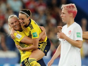 Sweden's Stina Blackstenius celebrates scoring their first goal with Sweden's Kosovare Asllani as Canada's Sophie Schmidt looks on at the Parc des Princes in Paris France on June 24, 2019.