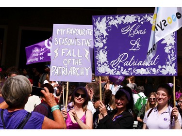 Protests carry placards as they attend a day-long and nationwide women's strike aimed at highlighting the country's poor record on defending the rights of women and families in Lausanne, Switzerland, June 14, 2019.