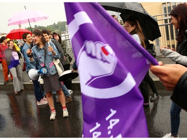 People protest with a sit-in on a bridge during a day-long and nationwide women's strike aimed at highlighting the country's poor record on defending the rights of women and families in Lausanne, Switzerland, June 14, 2019.