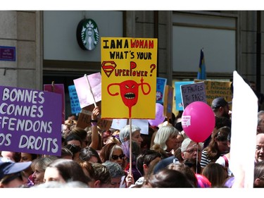 People hold placards as they attend a day-long and nationwide women's strike aimed at highlighting the country's poor record on defending the rights of women and families in Lausanne, Switzerland, June 14, 2019.