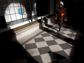 A woman walks through the arches of the Hudson's Bay store in downtown Calgary on Monday, April 3, 2017.