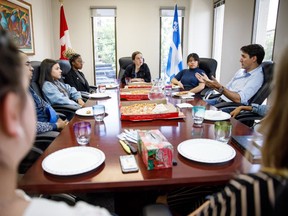 Justin Trudeau speaks with the Papineau Youth Council in Montreal in this photo posted to his Twitter page on Monday, June 24, 2019. The federal Conservatives are attacking Prime Minister Justin Trudeau for hypocrisy over plastic cutlery that was available at a lunch meeting with youth activists in his Montreal riding. Trudeau tweeted a picture of himself having lunch with about half a dozen members of the Papineau Youth Council Monday, including pizzas in cardboard boxes, paper plates, a pitcher of water with glasses, and a handful of plastic forks.