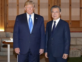 In this handout image provided by South Korean Presidential Blue House, U.S. President Donald Trump stands with South Korean President Moon Jae-in during their dinner on June 29, 2019 in Seoul, South Korea. (South Korean Presidential Blue House via Getty Images)