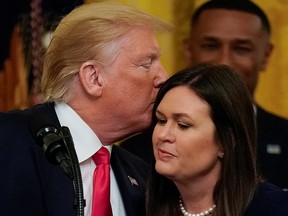 U.S. President Donald Trump kisses White House press secretary Sarah Sanders after it was announced she will leave her job at the end of the month during a second chance hiring prisoner reentry event in the East Room of the White House in Washington, D.C., June 13, 2019.
