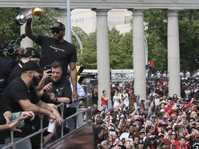 Kawhi Leonard holds his playoffs MVP trophy during the Raptors Championship parade in Toronto on June 17, 2019. Veronica Henri/Toronto Sun