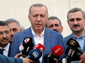 Turkish President Tayyip Erdogan talks to media after the Eid al-Fitr prayers to mark the end of the holy month of Ramadan in Istanbul, Turkey, June 4, 2019.