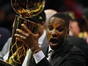 Raptors president Masai Ujiri holds up the Larry OBrien trophy. USA TODAY