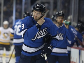 Winnipeg Jets defenceman Jacob Trouba straps up as he gets ready to face the Pittsburgh Penguins in Winnipeg on Tues., Nov. 27, 2018. The Jets need to deal with pending restricted free agent Trouba before making other moves says Ken Wiebe.