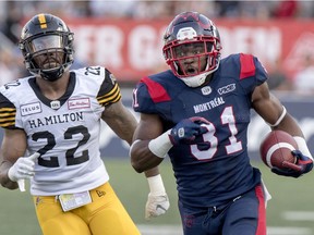 Will Stanback runs away from Hamilton Tiger-Cats Justin Tuggle for a long gain during CFLgame in Montreal on Thursday, July 4, 2019.