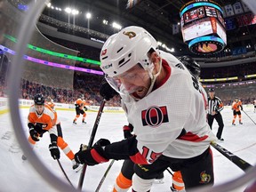 Senators' Zack Smith digs for the puck in the corner against the Philadelphia Flyers in the first period at Wells Fargo Center in Philadelphia, Pennsylvania.