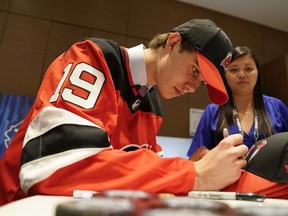 Jack Hughes signs his autograph after being selected first overall by the New Jersey Devils during the first round of the 2019 NHL Draft at Rogers Arena on June 21, 2019 in Vancouver, Canada.