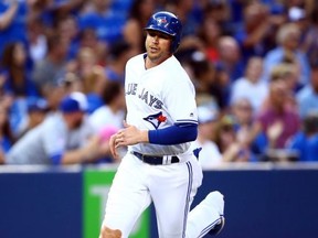 Justin Smoak of the Toronto Blue Jays scores on a ground rule double by Freddy Galvis #16 in the fourth inning during a MLB game against the Tampa Bay Rays at Rogers Centre on July 26, 2019 in Toronto.
