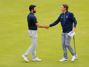 Cameron Smith of Australia, right, shakes hands with Adam Hadwin of Canada on the 18th green during the second round of the 148th Open Championship held on the Dunluce Links at Royal Portrush Golf Club on July 19, 2019 in Portrush, Northern Ireland. (Kevin C. Cox/Getty Images)