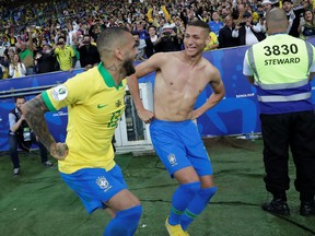 Brazil's Richarlison, right, celebrates scoring their third goal with Dani Alves during the Copa America finals at Maracana Stadium, Rio de Janeiro, July 7, 2019 . (REUTERS/Henry Romero)