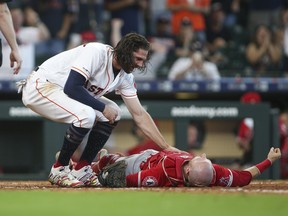 Houston Astros centre fielder Jake Marisnick, left, reacts after a collision at the plate with Los Angeles Angels catcher Jonathan Lucroy during the eighth inning at Minute Maid Park. (Troy Taormina-USA TODAY Sports)