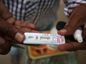 A health worker shows a malaria rapid test kit after collecting blood sample from a resident during a drive to prevent the spread of mosquito-borne diseases in Ahmedabad, India, October 26, 2018. REUTERS/Amit Dave/File Photo