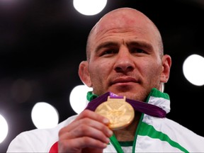 Uzbekistan's Artur Taymazov poses with his gold medal at the podium of the Men's 120Kg Freestyle wrestling at the ExCel venue during the London 2012 Olympic Games August 11, 2012. (REUTERS/Grigory Dukor/File Photo)