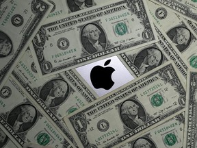 U.S. dollar banknotes and the Apple logo are seen in this photo illustration taken August 3, 2018. REUTERS/Dado Ruvic/Illustration/File Photo