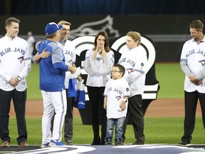John Gibbons greets Brandi Halladay, the widow of former Blue Jays ace Roy Halladay, and his two sons in a ceremony on Opening Day in 2018.
