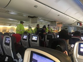 Emergency workers assist passengers of Air Canada AC33 flight, which diverted to Hawaii after turbulence, at Honolulu airport, Hawaii, U.S., July 11, 2019 in this image obtained from social media.