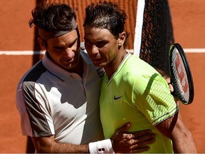 Spain's Rafael Nadal hugs Switzerland's Roger Federer after winning their men's singles semi-final match on day 13 of The Roland Garros 2019 French Open tennis tournament in Paris on June 7, 2019.