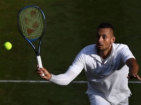 Australia's Nick Kyrgios returns against Spain's Rafael Nadal during their men's singles second round match on the fourth day of the 2019 Wimbledon Championships at The All England Lawn Tennis Club in Wimbledon, southwest London, on July 4, 2019.