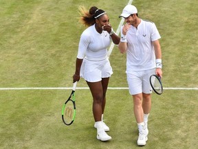 Britain's Andy Murray and US player Serena Williams talk as they play Brazil's Bruno Soares and US players Nicole Melichar during their mixed doubles third round match on day nine of the 2019 Wimbledon Championships at The All England Lawn Tennis Club in Wimbledon, southwest London, on July 10, 2019.