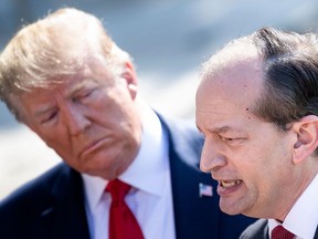 US President Donald Trump listens to US Labour Secretary Alexander Acosta during a media address early July 12, 2019 at the White House in Washington, DC. - Alex Acosta announced his resignation as US labor secretary Friday, amid criticism of a secret plea deal he negotiated a decade ago with Jeffrey Epstein, the financier accused of sexually abusing young girls. "I called the president this morning and told him that I thought the right thing was to step aside," Acosta said in a joint appearance with President Donald Trump at the White House.