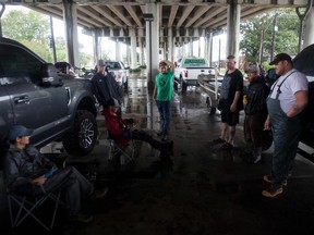 Individuals gather in Morgan City, Louisana, Saturday, July 13,2019 ahead of Tropical Storm Barry in case rescue help is needed due to the threat of flooding in the area. - Tropical Storm Barry is the first tropical storm system of 2019 to make landfall in the United States the storm is around 10 miles offshore from Louisiana. Barry will dump up to two feet of rain along with strong winds and storm-surge flooding according to weather reports.