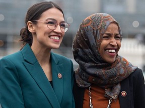 In this file photo taken on Feb. 7, 2019 U.S. Representative Alexandria Ocasio-Cortez, Democrat of New York, and US Representative Ilhan Omar (R), Democrat of Minnesota, attend a press conference calling on Congress to cut funding for US Immigration and Customs Enforcement (ICE) and to defund border detention facilities, outside the US Capitol in Washington, D.C.