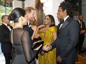 Britain's Prince Harry, Duke of Sussex and Britain's Meghan, Duchess of Sussex meet cast and crew, including US singer-songwriter Beyoncé and her husband, US rapper Jay-Z  as they attend the European premiere of the film The Lion King in London on July 14, 2019.