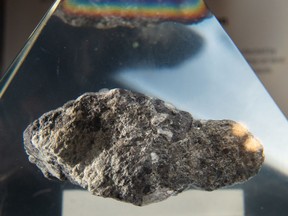 A rock from the moon is seen displayed inside a plexiglass case during a gala reuniting the Apollo team responsible for the historic lunar landing 50 years ago aboard the USS Hornet in Alameda, Calif. on July 16, 2019. (JOSH EDELSON/AFP/Getty Images)