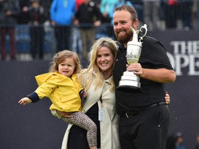 Ireland's Shane Lowry poses with his family and the Claret Jug, the trophy for the Champion golfer of the year after winning the British Open golf Championships at Royal Portrush golf club in Northern Ireland on July 21, 2019. (/AFP/Getty Images