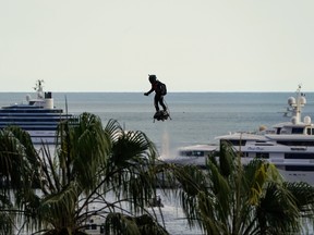 In this file photo taken on May 15, 2018, Zapata CEO Franky Zapata flies a jet-powered hoverboard or "Flyboard" during the 71st edition of the Cannes Film Festival in Cannes, southern France. (LAURENT EMMANUEL/AFP/Getty Images)