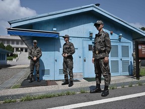 South Korean soldiers stand guard at the truce village of Panmunjom in the Demilitarized Zone (DMZ) dividing the two Koreas on July 27, 2019 after a commemorative ceremony for the 66th anniversary of the Korean War Armistice Agreement. (YEON-JE JUNG,JUNG YEON-JE/AFP/Getty Images)