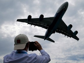 A visitor takes a picture of an Airbus A380 as it lands after an air display at the 53rd International Paris Air Show at Le Bourget Airport near Paris, France June 23, 2019. (REUTERS/Pascal Rossignol)