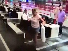 A confused first-time flyer, climbs on to the baggage conveyor belt, believed it would help her board the plane. Istanbul Airport CCTV footage screenshot
