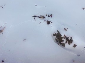 This photo taken and handout on January 25, 2018 by the Italian National Alpine and Speleological Rescue Corps of the Aosta Valley shows recuers near the wreckage of a helicopter, close to La Thuile, northwestern Italian Alps. (HANDOUT/AFP/Getty Images)