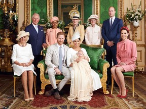 This official handout Christening photograph released by the Duke and Duchess of Sussex shows Britain's Prince Harry, Duke of Sussex (centre left), and his wife Meghan, Duchess of Sussex holding their baby son, Archie Harrison Mountbatten-Windsor flanked by (L-R) Britain's Camilla, Duchess of Cornwall, Britain's Prince Charles, Prince of Wales, Ms Doria Ragland, Lady Jane Fellowes, Lady Sarah McCorquodale, Britain's Prince William, Duke of Cambridge, and Britain's Catherine, Duchess of Cambridge in the Green Drawing Room at Windsor Castle, west of London on July 6, 2019. (Chris ALLERTON / SUSSEXROYAL / AFP)