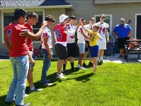 Christian Larsen celebrates his ninth birthday with Nampa High School football team.