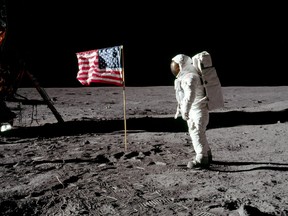 Astronaut Buzz Aldrin poses for a photograph beside the deployed United States flag during an extravehicular activity (EVA) on the moon, July 20, 1969. (Neil Armstrong/NASA/Handout via REUTERS)