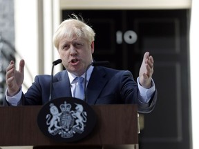 Britain's new Prime Minister Boris Johnson gestures as he speaks outside 10 Downing Street, London, Wednesday, July 24, 2019. Boris Johnson pledged a Halloween Brexit for Britain from the European Union, negotiated or not, "no ifs or buts", after being sworn in Wednesday as Britain's prime minister.