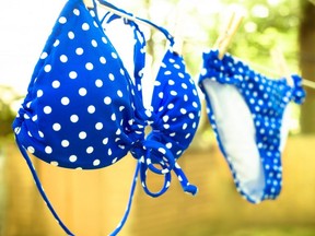 Retro toned polka dot bikini on clothesline.
