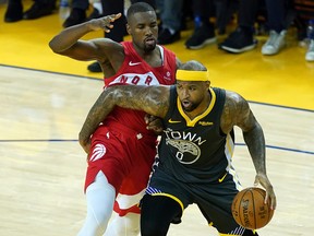 DeMarcus Cousins of the Golden State Warriors is defended by Serge Ibaka of the Toronto Raptors at ORACLE Arena on June 13, 2019 in Oakland. (Thearon W. Henderson/Getty Images)